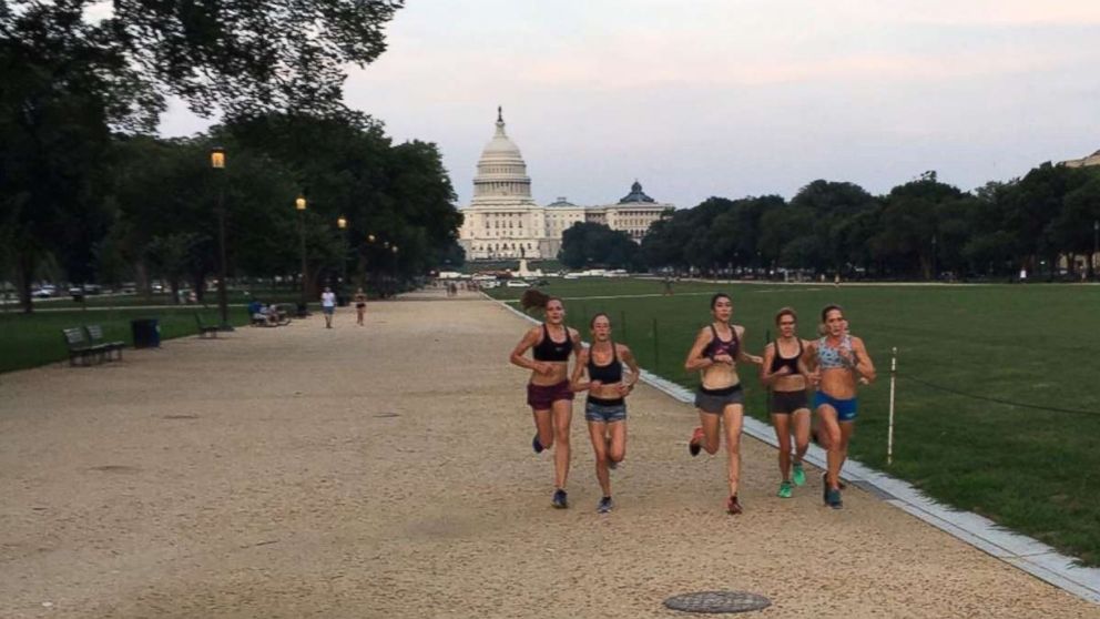 PHOTO: Alex Morris, center, and Kerry Allen, fourth from left in a black sports bra, train with the Georgetown Running Club on the National Mall.
