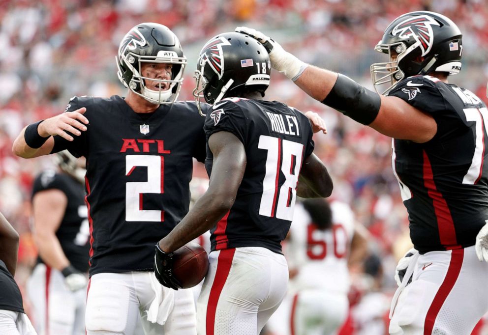 PHOTO: Calvin Ridley, center #18, celebrates his third quarter touchdown against the Tampa Bay Buccaneers with Matt Ryan, right #2, during the game on Sept. 19, 2021, in Tampa, Fla.
