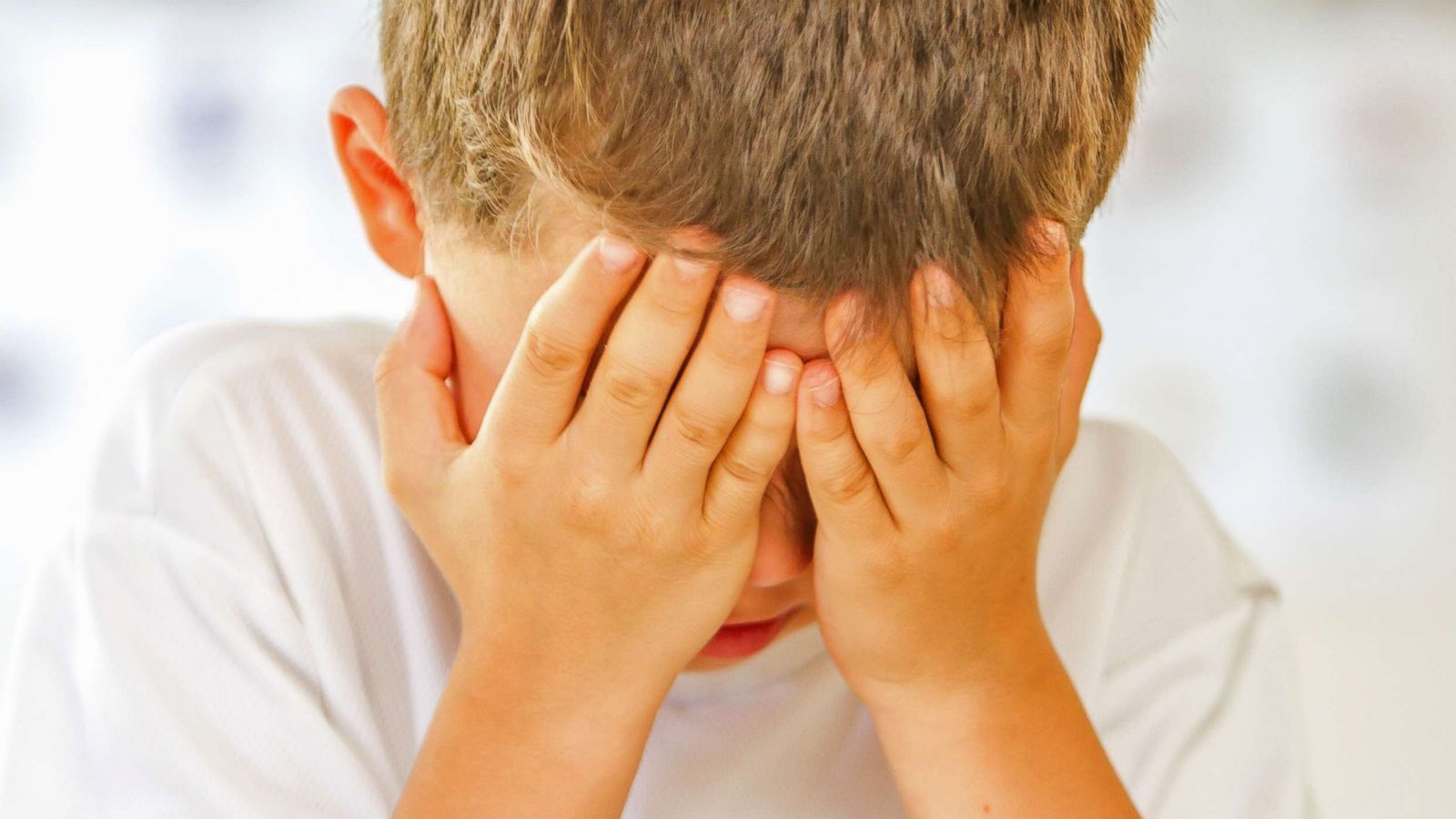 PHOTO: A boy puts his hands over his face in an undated stock photo.