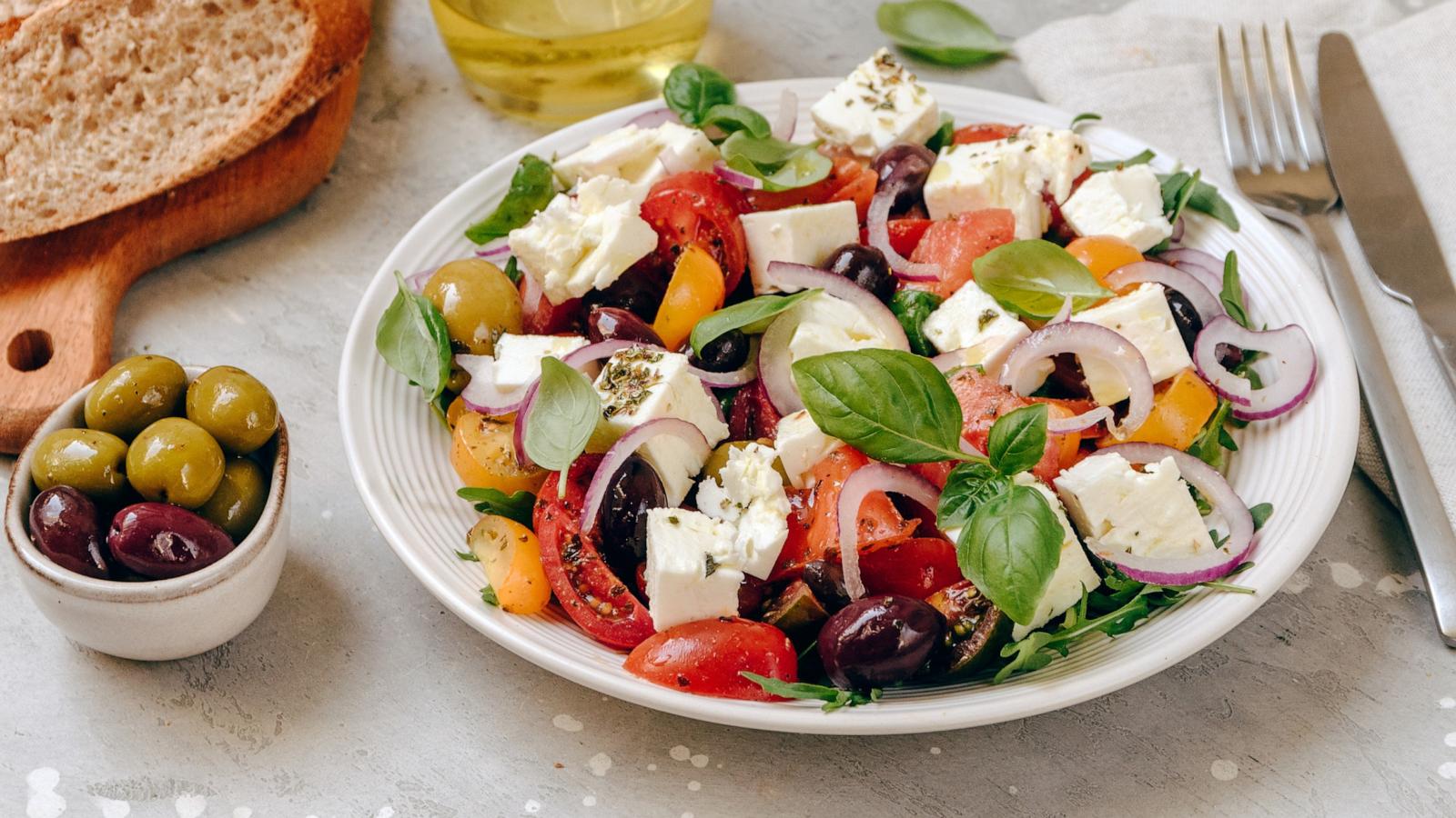 PHOTO: Greek salad with feta cheese, fresh tomatoes, basil, onion olives and olive oil, healthy food.