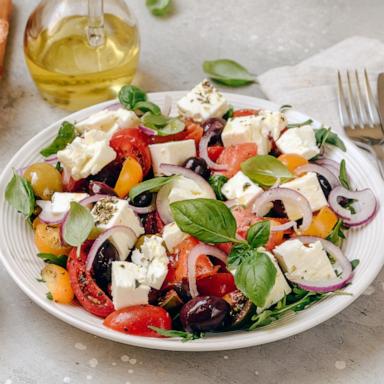 PHOTO: Greek salad with feta cheese, fresh tomatoes, basil, onion olives and olive oil, healthy food.