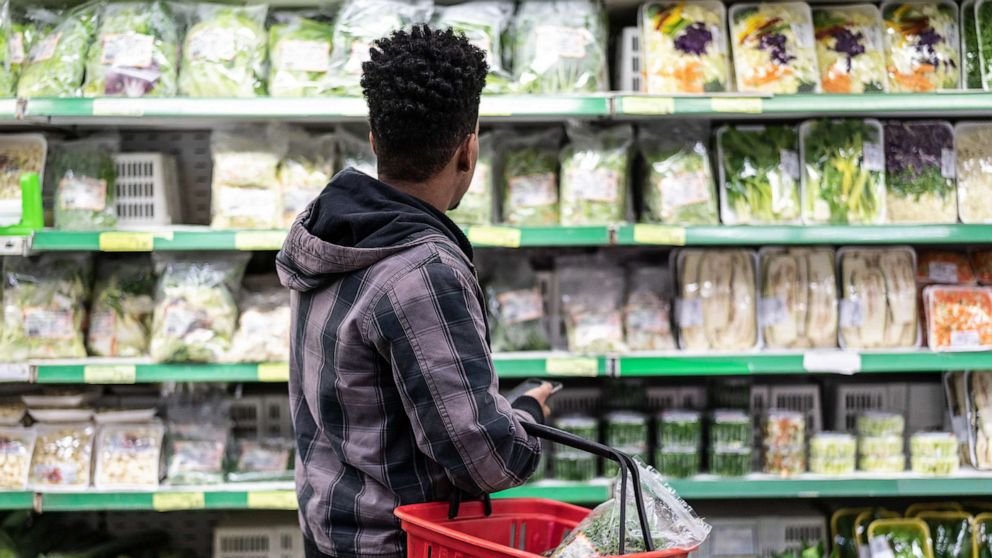 PHOTO: A stock photo of a shopper in the bagged produce aisle of a grocery store.