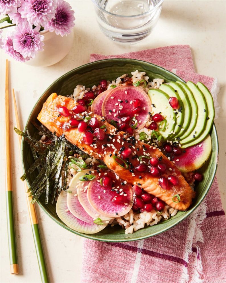 Photo: Salmon and brown rice bowl with vegetables and pomegranate.