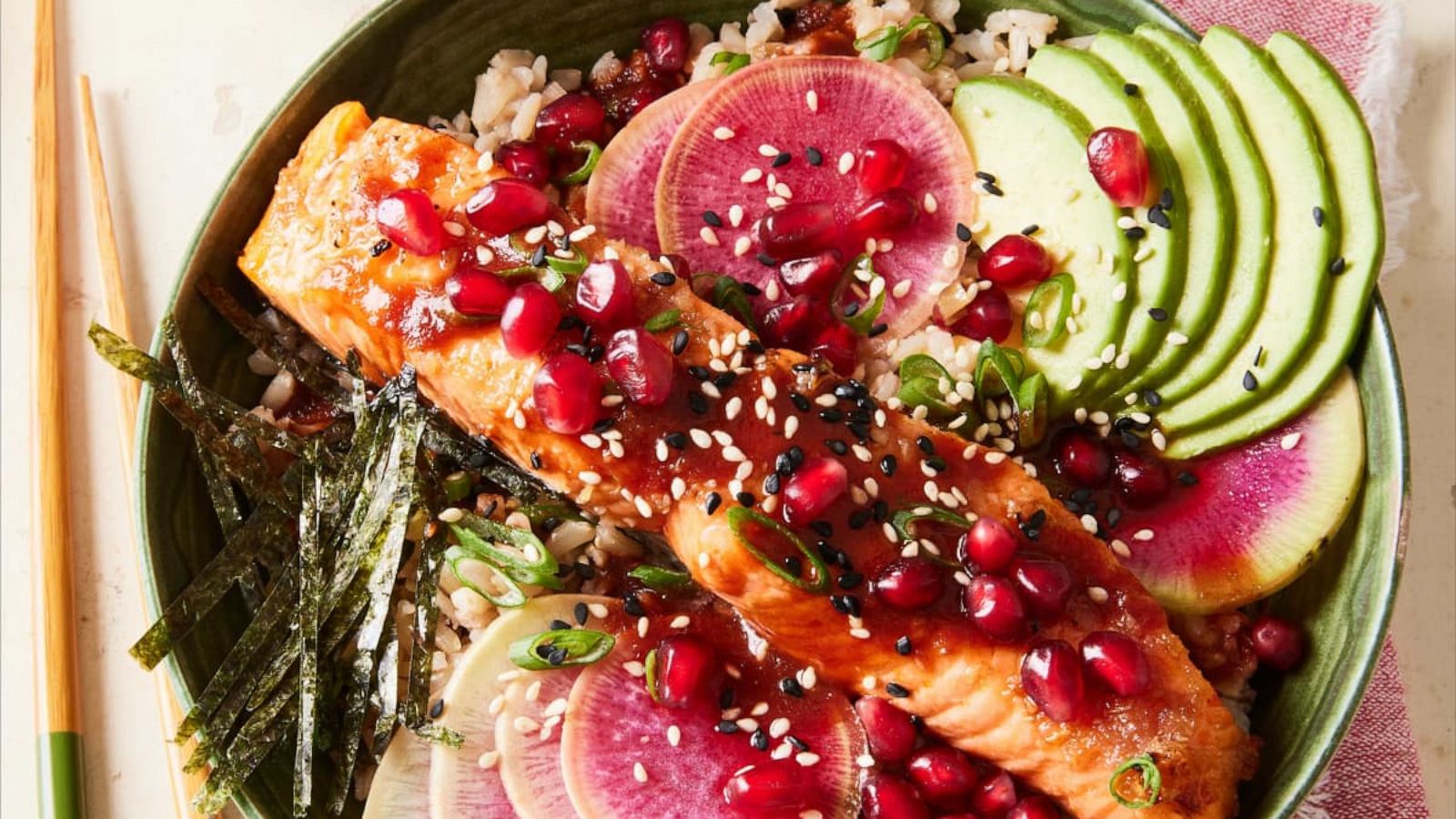 PHOTO: A pomegranate salmon and rice bowl with fresh veggies and nori.
