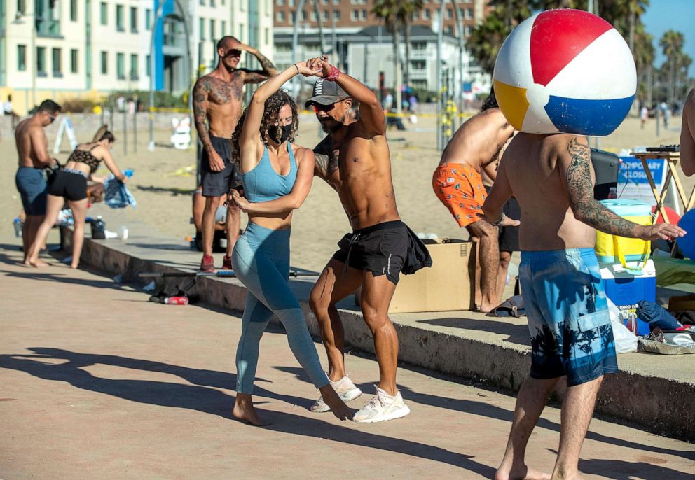 PHOTO: Gabriela Short and Julio Escobar dance to salsa music, in between working out at Santa Monica Beach, Calif., Aug. 9, 2020.