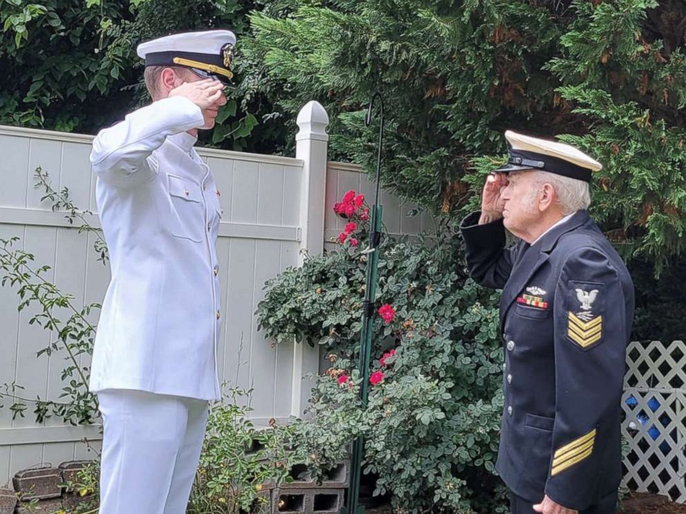 PHOTO: Ensign Nicholas Allen salutes his grandfather, Navy veteran Gail Allen.