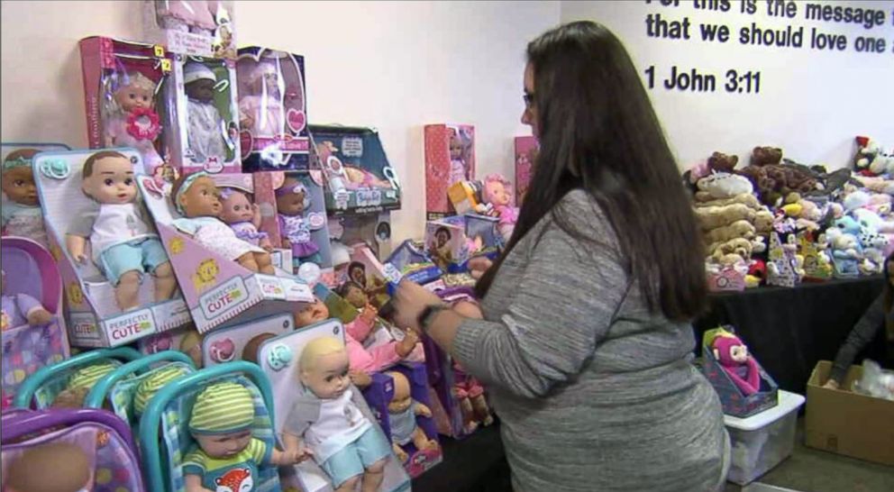 PHOTO: Ilea Faircloth, the principal of Springfield Elementary School in Panama City, Fla., arranges dolls at the free toy drive for community members.