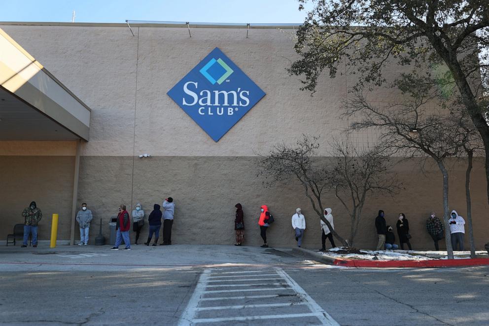 PHOTO: In this Feb. 20, 2021 file photo, people wait for a Sam's Club store to open in Austin, Texas. 