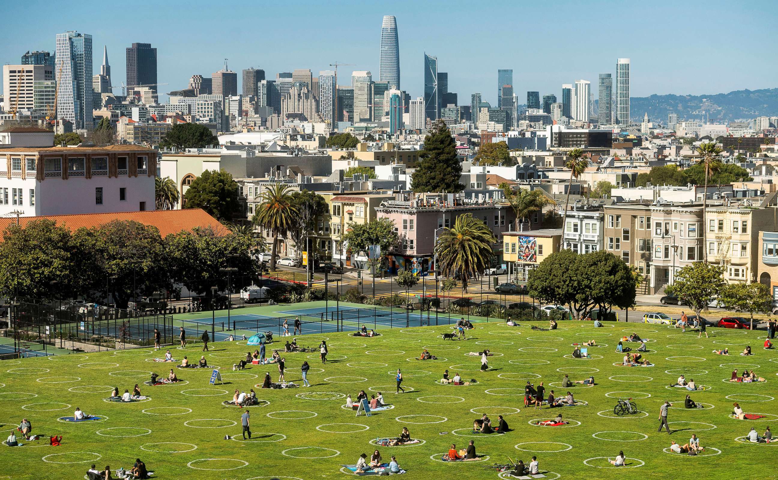 PHOTO: Circles designed to help prevent the spread of the coronavirus by encouraging social distancing line San Francisco's Dolores Park, May 21, 2020.