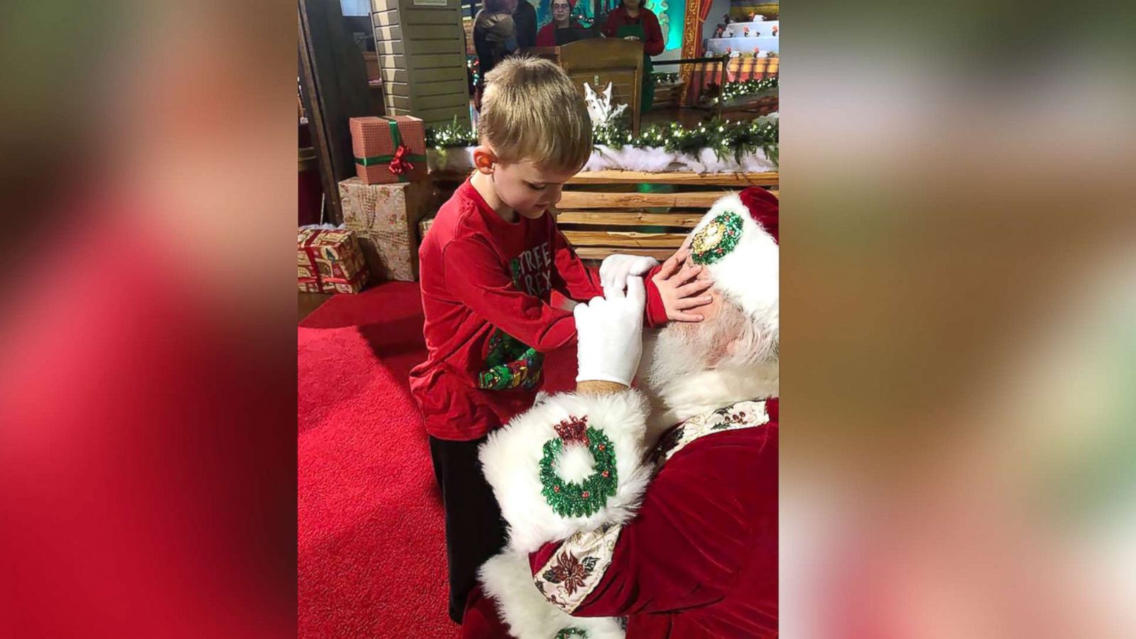 PHOTO: A photo shows Santa Claus allowing Matthew Foster, 6, explore his beard, face, hat and coat.