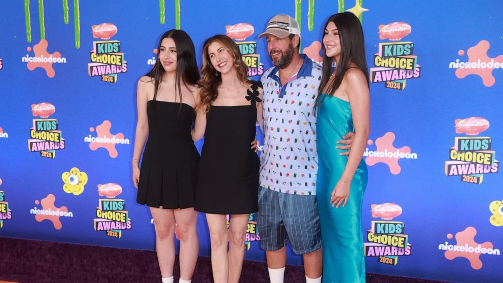 PHOTO: Sadie Sandler, Jackie Sandler, Adam Sandler and Sunny Sandler pose on the orange carpet for the 37th Annual Nickelodeon Kids' Choice Awards at The Barker Hangar in Santa Monica, Calif., July 13, 2024. 