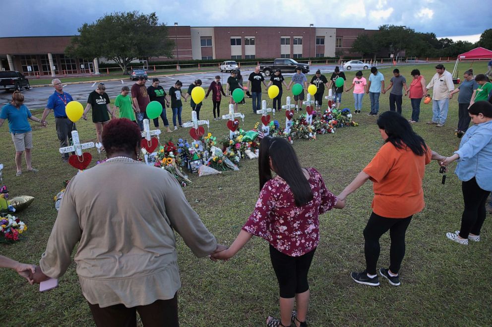 PHOTO: Mourners pray around a memorial in front of Santa Fe High School on May 21, 2018 in Santa Fe, Texas. In May 18, 2018, 17-year-old student Dimitrios Pagourtzis entered the school with a shotgun and a pistol and opened fire, killing 10 people.  