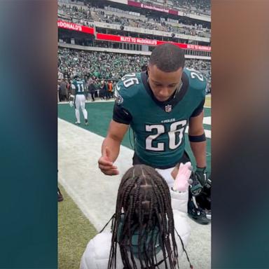 PHOTO: Philadelphia Eagles running back Saquon Barkley shared a handshake with his daughter Jan. 26, ahead of the NFC championship game between the Eagles and the Washington Commanders.