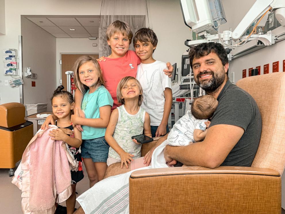 PHOTO: Micah Love poses with his infant son Lincoln and five older children at Nemours Children's Hospital in Orlando.