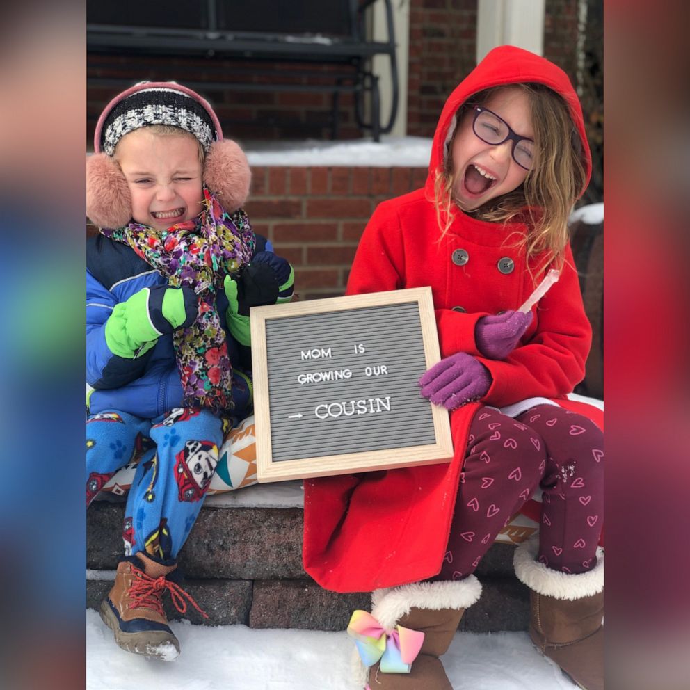 PHOTO: Cathey Stoner's children, Samson and Ruthie, hold a sign announcing their mom's pregnancy, in an undated family photo.