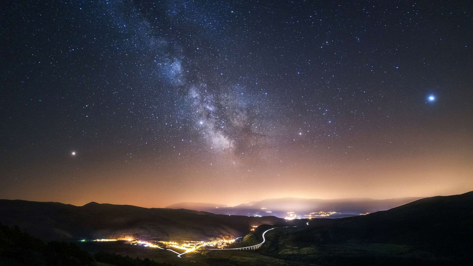 PHOTO: This undated file photo shows the town of Assergi, Italy. The bright reddish star at left is Mars, Saturn is at the middle of the image, and the bright star on the right is Jupiter.