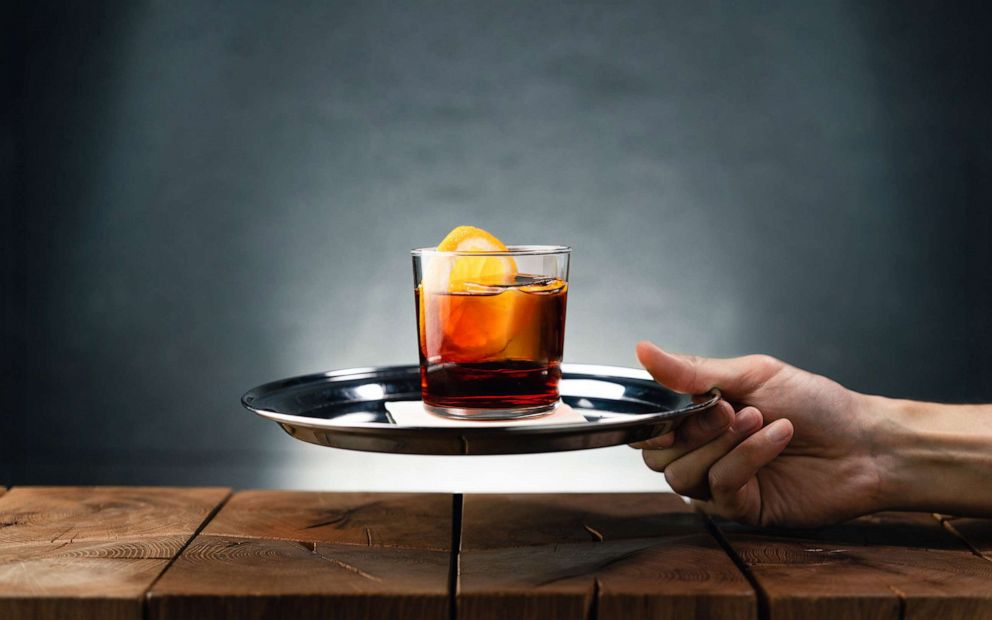 PHOTO: A Negroni sbagliato cocktail is presented on a tray.