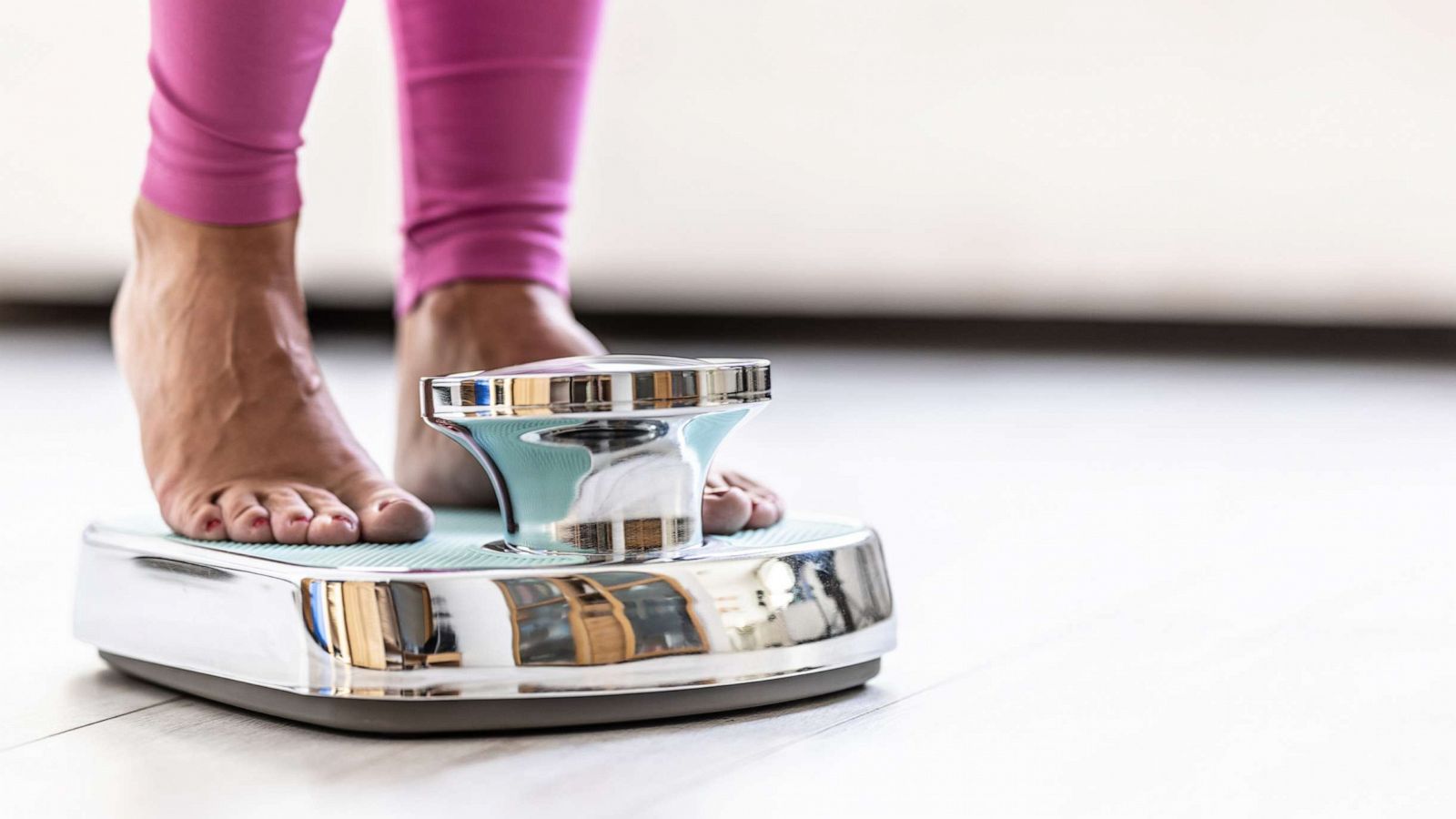 PHOTO: A woman steps on a scale to weigh herself in an undated stock photo.