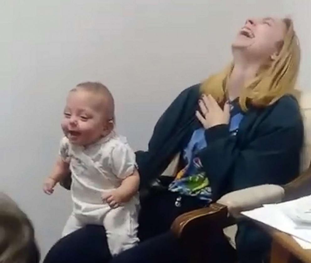 PHOTO: Carol Benjamin laughs in a video that she shared of her daughter Scarlet, 11 months, hearing for the first time on Facebook, where it garnered 188,000 views.