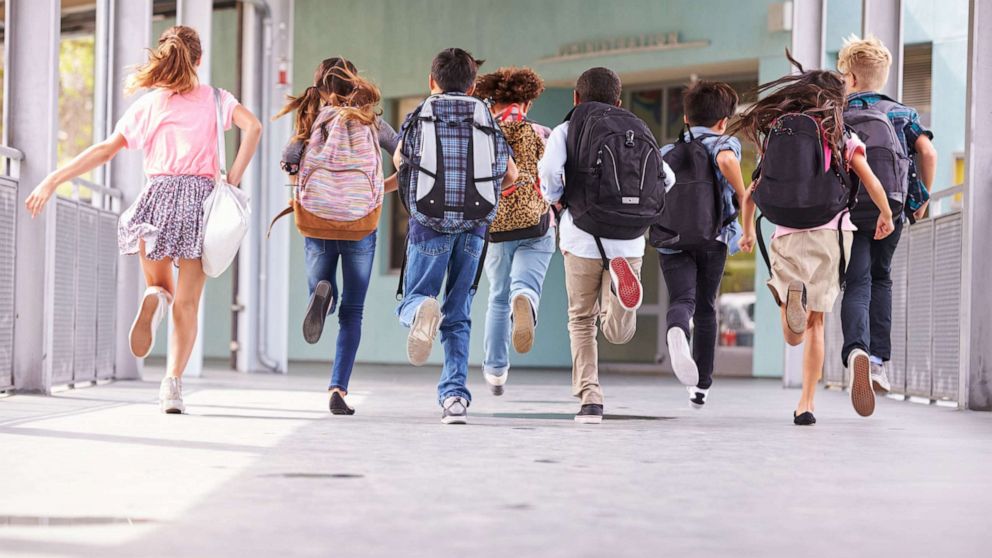 PHOTO: A group of elementary school kids run towards school in an undated stock photo.