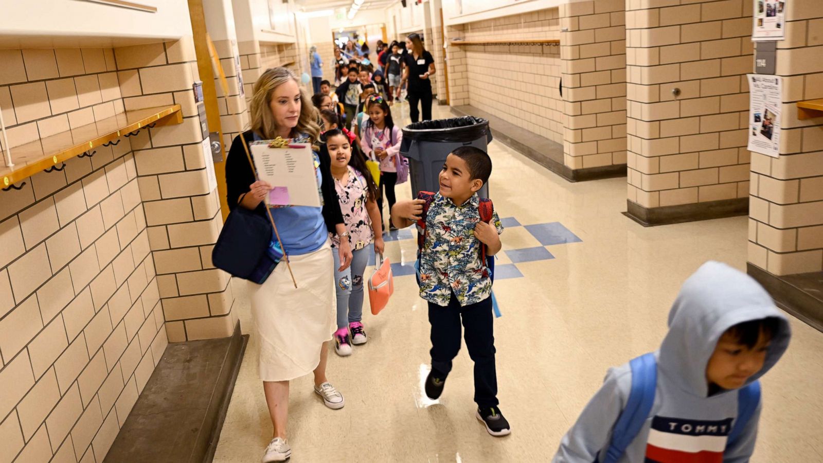 PHOTO: Denver Public School students at Ellis Elementary School follow their 1st grade teacher Megan Westmore to her classroom for the return of the 2022-23 school year, Aug. 22, 2022, in Denver.