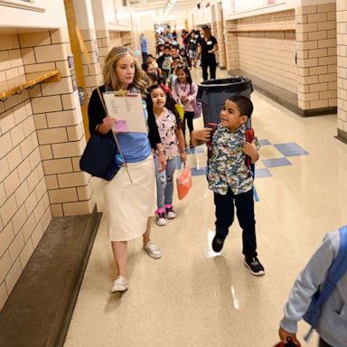 PHOTO: Denver Public School students at Ellis Elementary School follow their 1st grade teacher Megan Westmore to her classroom for the  return of the 2022-23 school year, Aug. 22, 2022, in Denver.