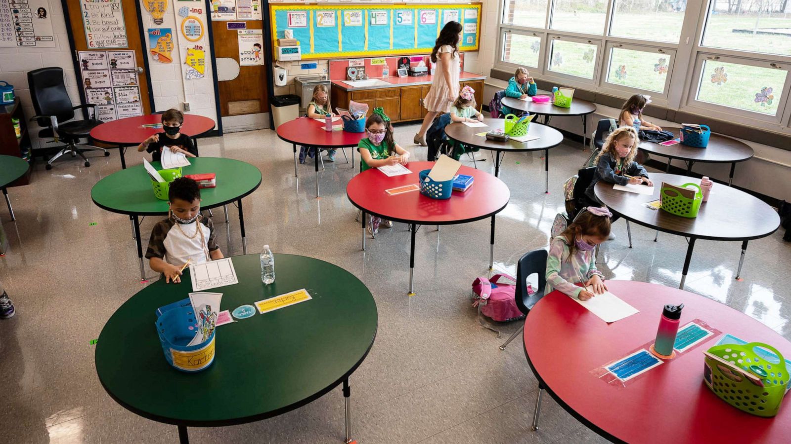 PHOTO: A teacher walks among the the masked students sitting in a socially distanced classroom session at Medora Elementary School on March 17, 2021, in Louisville, Ky.