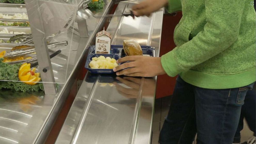 PHOTO: Students use trays to get lunch at a school cafeteria in Virginia.