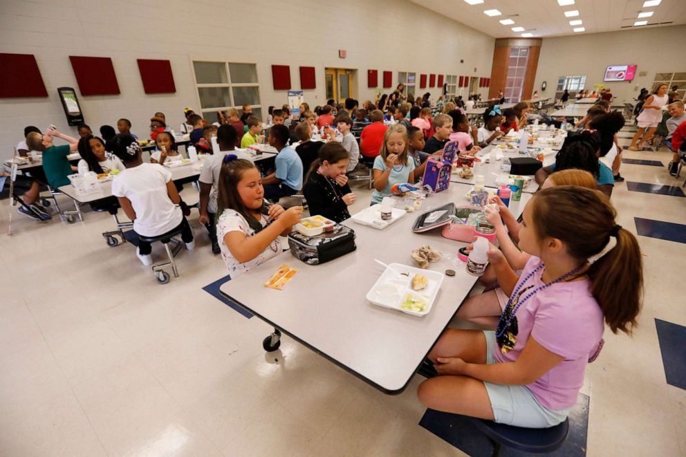 PHOTO: In this Aug. 9, 2019, file photo, students at Madison Crossing Elementary School in Canton, Miss., eat lunch in the school's cafeteria.