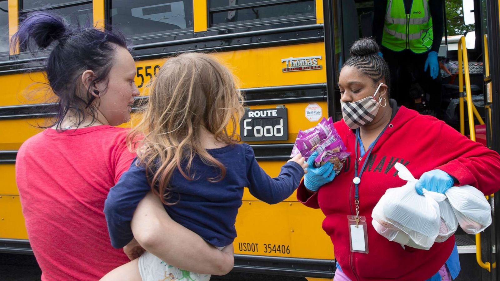 PHOTO: A nutritionist from the Seattle Public Schools Nutrition Services Department delivers meals to children and their families on May 6, 2020, in Seattle. They have distributed food since the school buildings closed due to the COVID-19 outbreak.