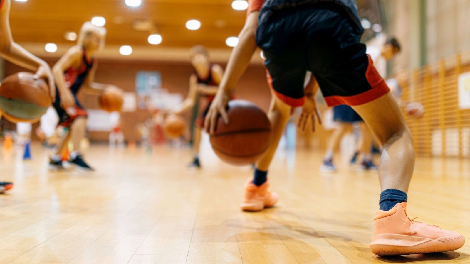 PHOTO: Stock photo of kids playing basketball in school.