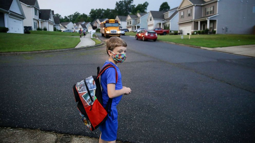 PHOTO: Paul Adams, 7, waits at the bus stop for the first day of school, Aug. 3, 2020, in Dallas, Ga.