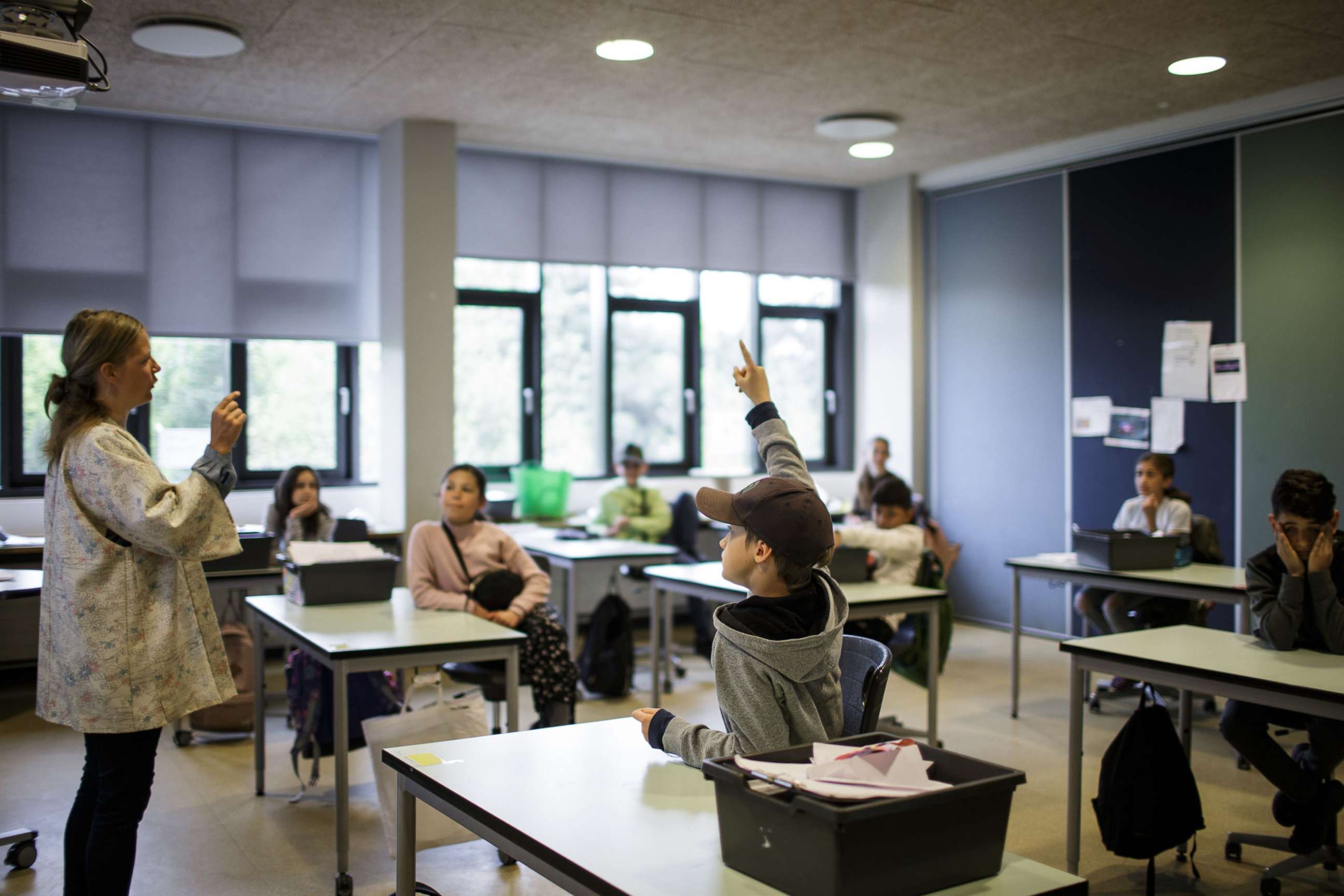 PHOTO: Teacher Marie Kaas-Larsen questions her pupils in a classroom rearrangered for social distancing at the Norrebro Park primary school in Copenhagen, April 29, 2020.
