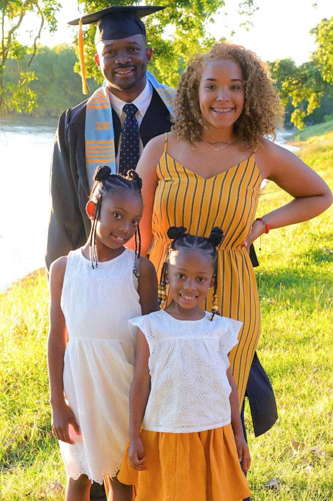 PHOTO: Edrius Stagg poses for a portrait with his daughters at an undergraduate graduation ceremony in 2019.