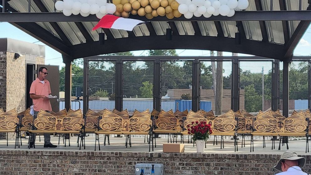 PHOTO: Sean Peacock stands with the 21 memorial benches he created for the victims of the May 24, 2022, deadly shooting at Robb Elementary School in Uvalde, Texas.