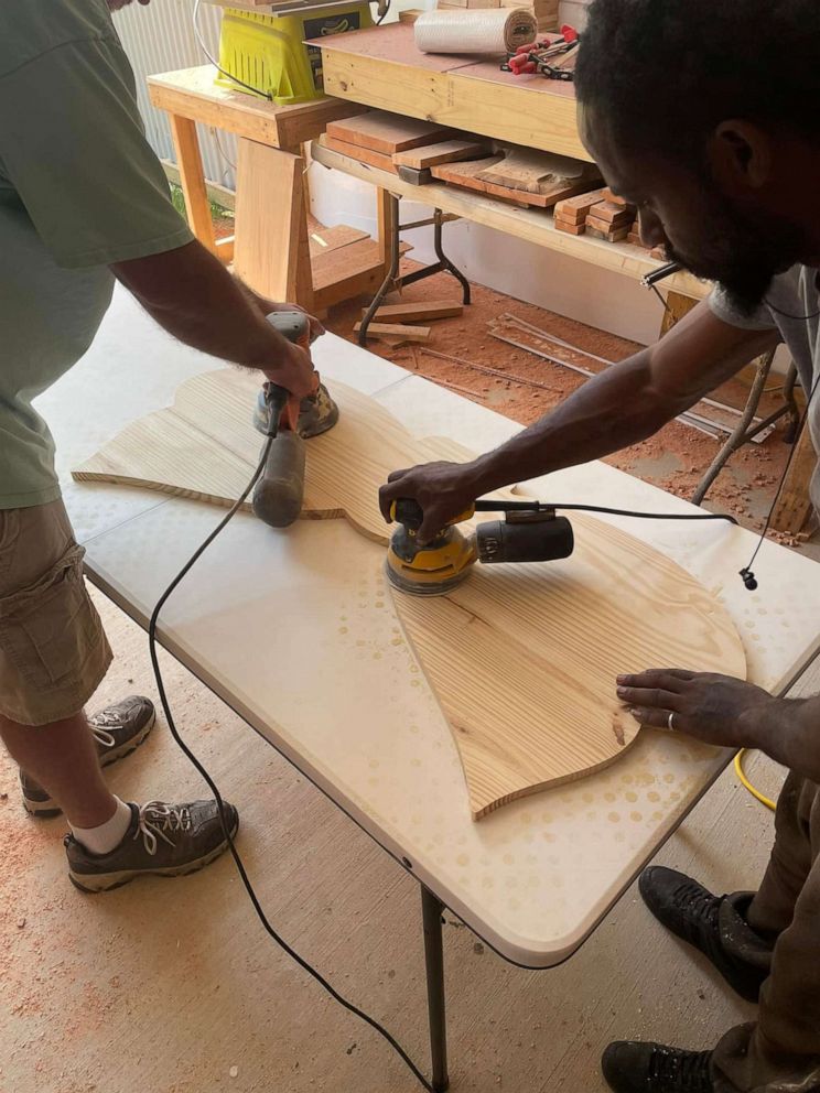 PHOTO: JassGraphix employees make one of the 21 butterfly memorial benches made in memory of the victims of the Robb Elementary School shooting.