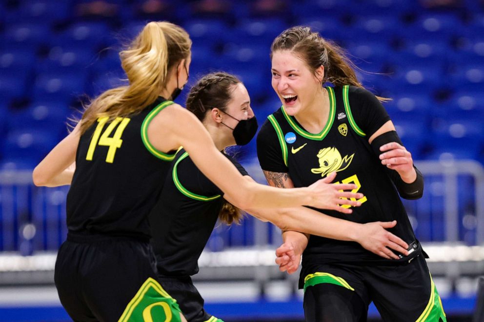 PHOTO: Sedona Prince of the Oregon Ducks celebrates with Lydia Giomi after defeating the Georgia Lady Bulldogs 57-50 in the second round game of the 2021 NCAA Women's Basketball Tournament at the Alamodome on March 24, 2021 in San Antonio, Texas.