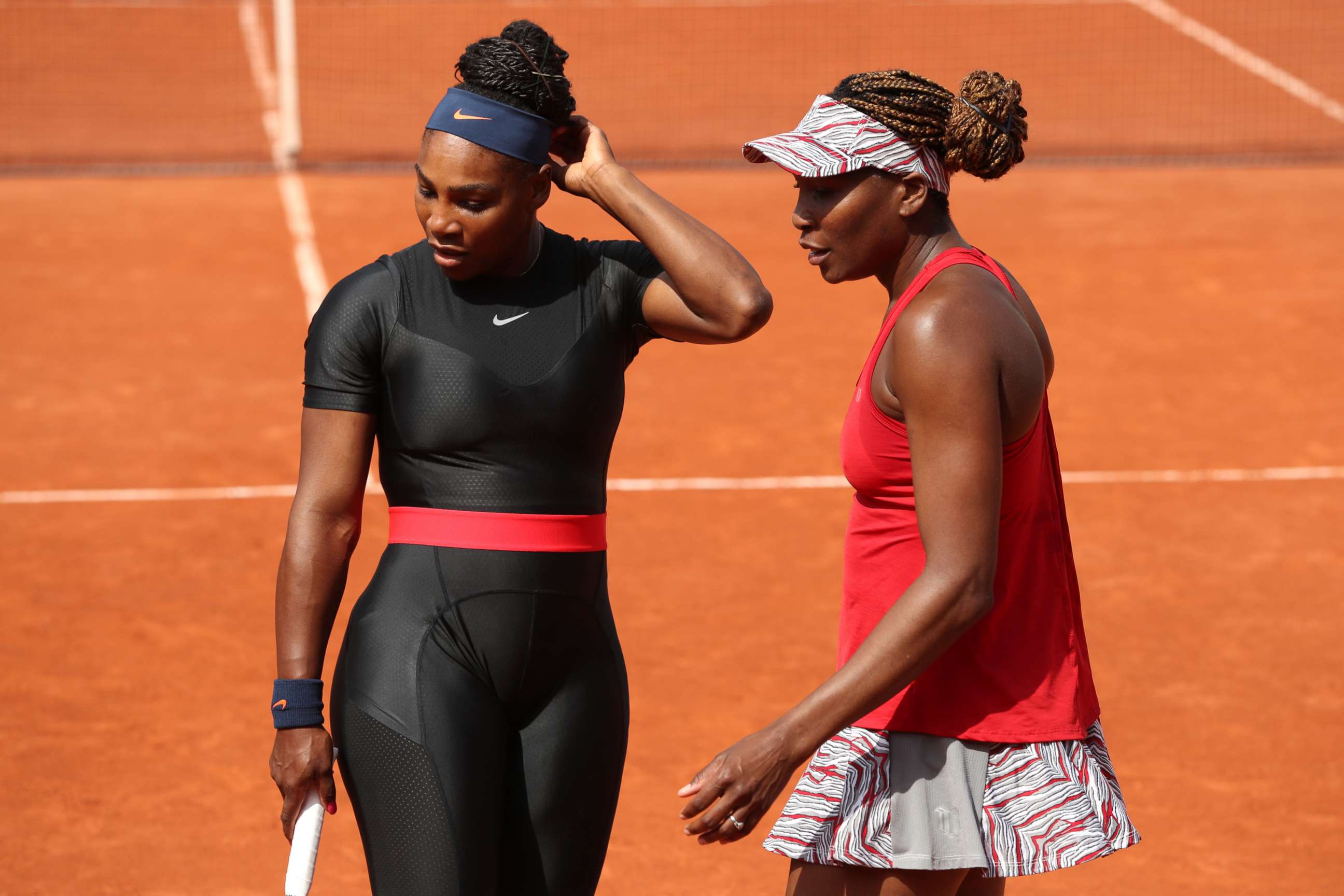 PHOTO: Serena Williams and Venus Williams talk during their ladies doubles match at the 2018 French Open, June 3, 2018 in Paris.