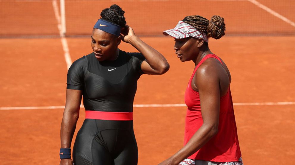 PHOTO: Serena Williams and Venus Williams talk during their ladies doubles match at the 2018 French Open, June 3, 2018 in Paris.