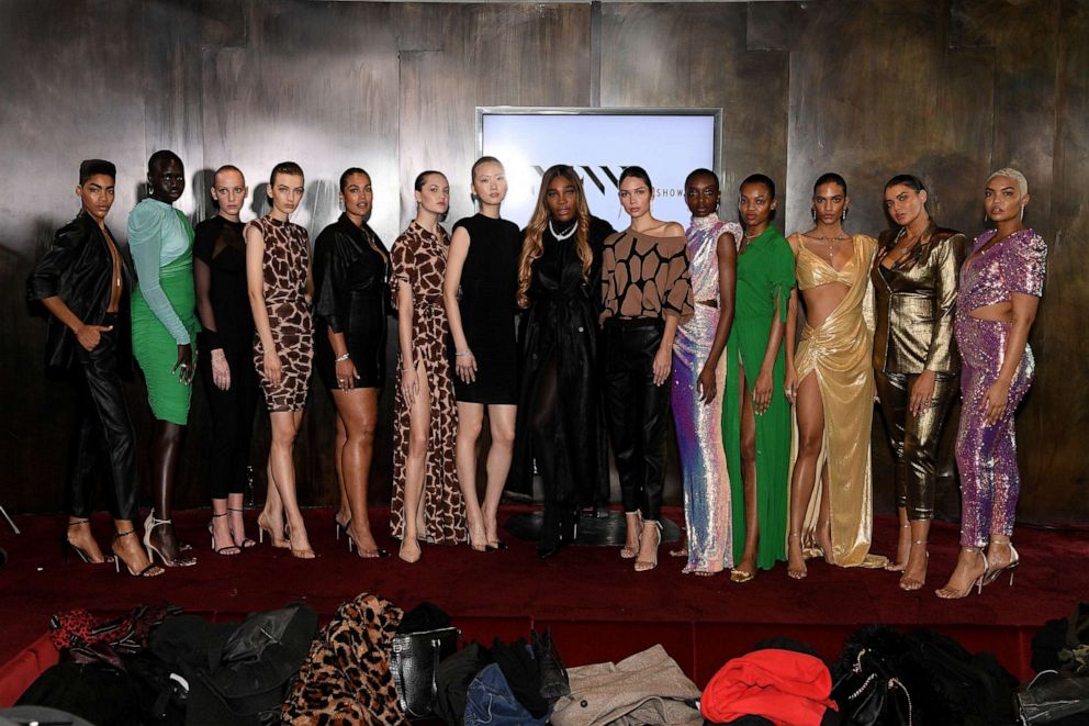 Tennis star Serena Williams poses with models during the launch of