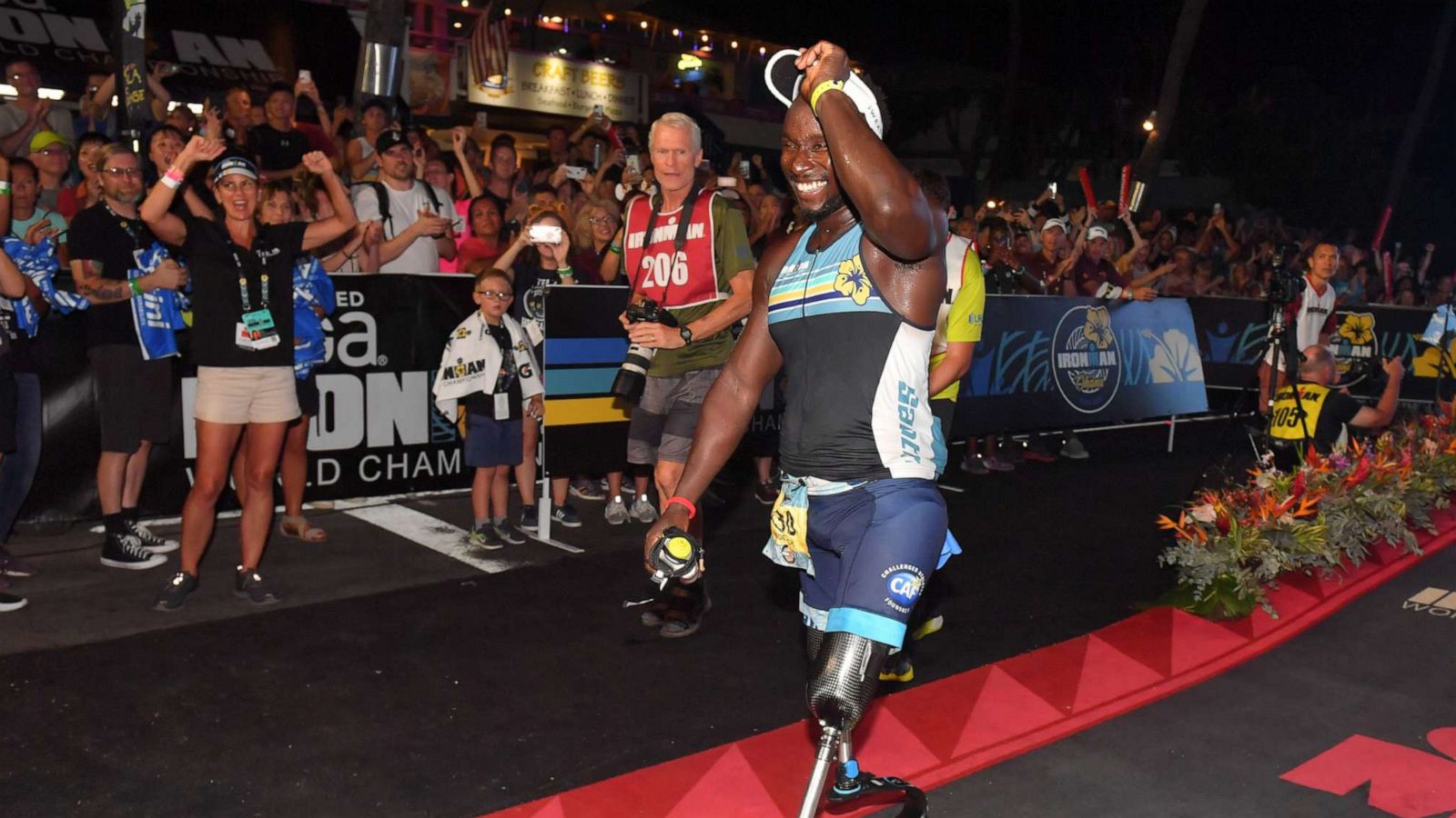 PHOTO:Roderick Sewell crosses the finish line at the 2019 Vega Ironman World Championships, Oct. 12, 2019, in Kona, Hawaii. Sewell is the first bilateral above the knee amputee to finish the championship on prosthetic legs.