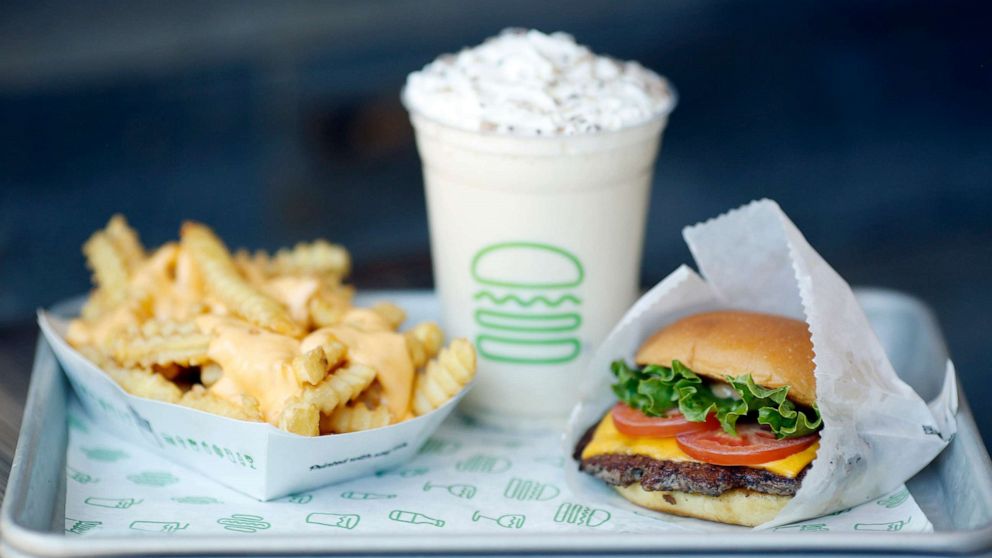 PHOTO: A ShackBurger, cheese fries, and milkshake are arranged for a photograph at a Shake Shack Inc. restaurant in Lexington, Ky., March 6, 2019. 