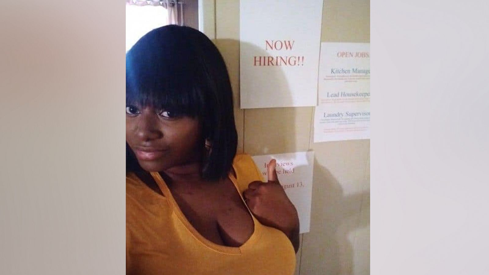 PHOTO: Shaketha McGregor, of Dublin, Georgia, poses in front of signs she made for her kids' job fair.