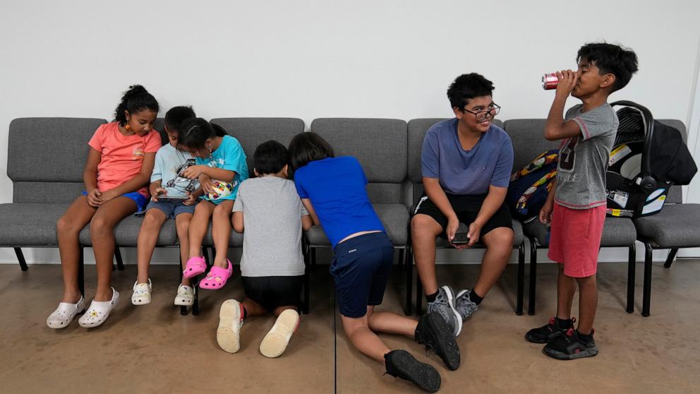 PHOTO: Children talk and play games inside St. Michael the Archangel Catholic church in the aftermath of Hurricane Helene, Oct. 4, 2024, in Erwin, Tenn. 