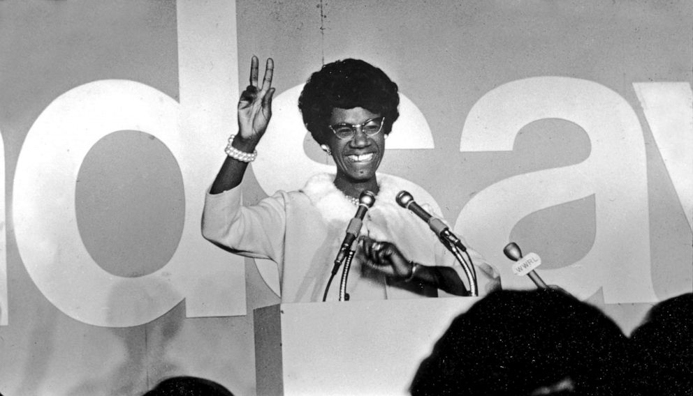 PHOTO: African American educator and U.S. congresswoman Shirley Chisholm stands at a podium and gives the victory sign, ca. 1968. 