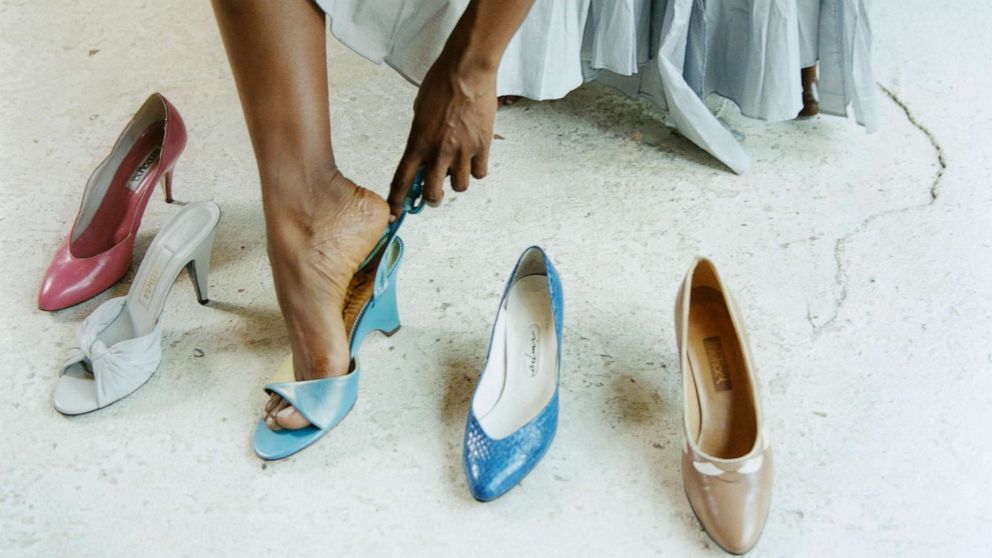 PHOTO: Woman trying on shoes in a shoe store.