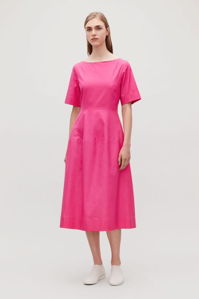 PHOTO: Style Hint: Embrace two of fall's fashion-forward trends in one dress: The minimalist waisted midi in knockout hot pink. Pair it with sneakers and simple accessories to let the color be the statement.