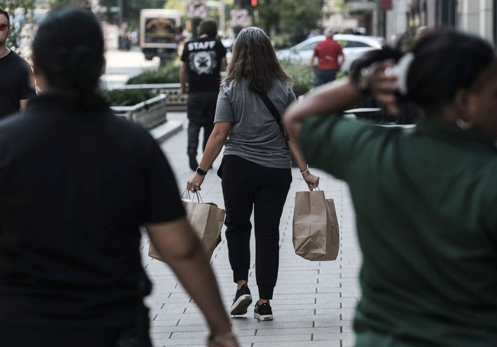 PHOTO: A woman carries shopping bags in Detroit, Sept. 14, 2022. 