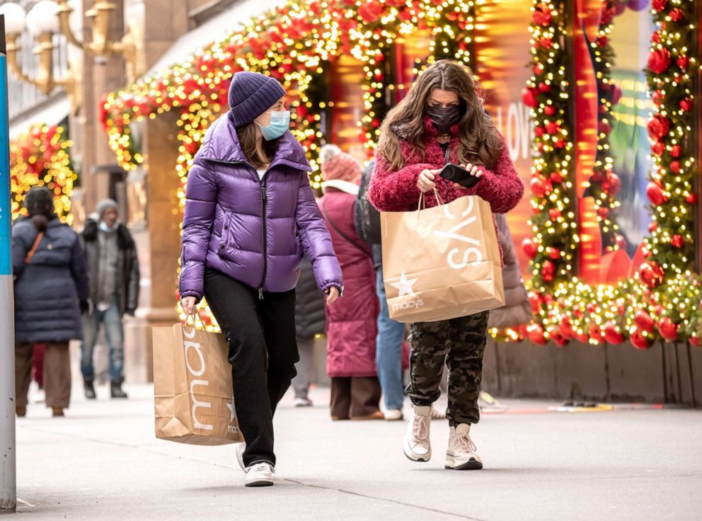 PHOTO: People wearing masks carry shopping bags outside of a Macy's store on Dec. 2, 2020 in New York.