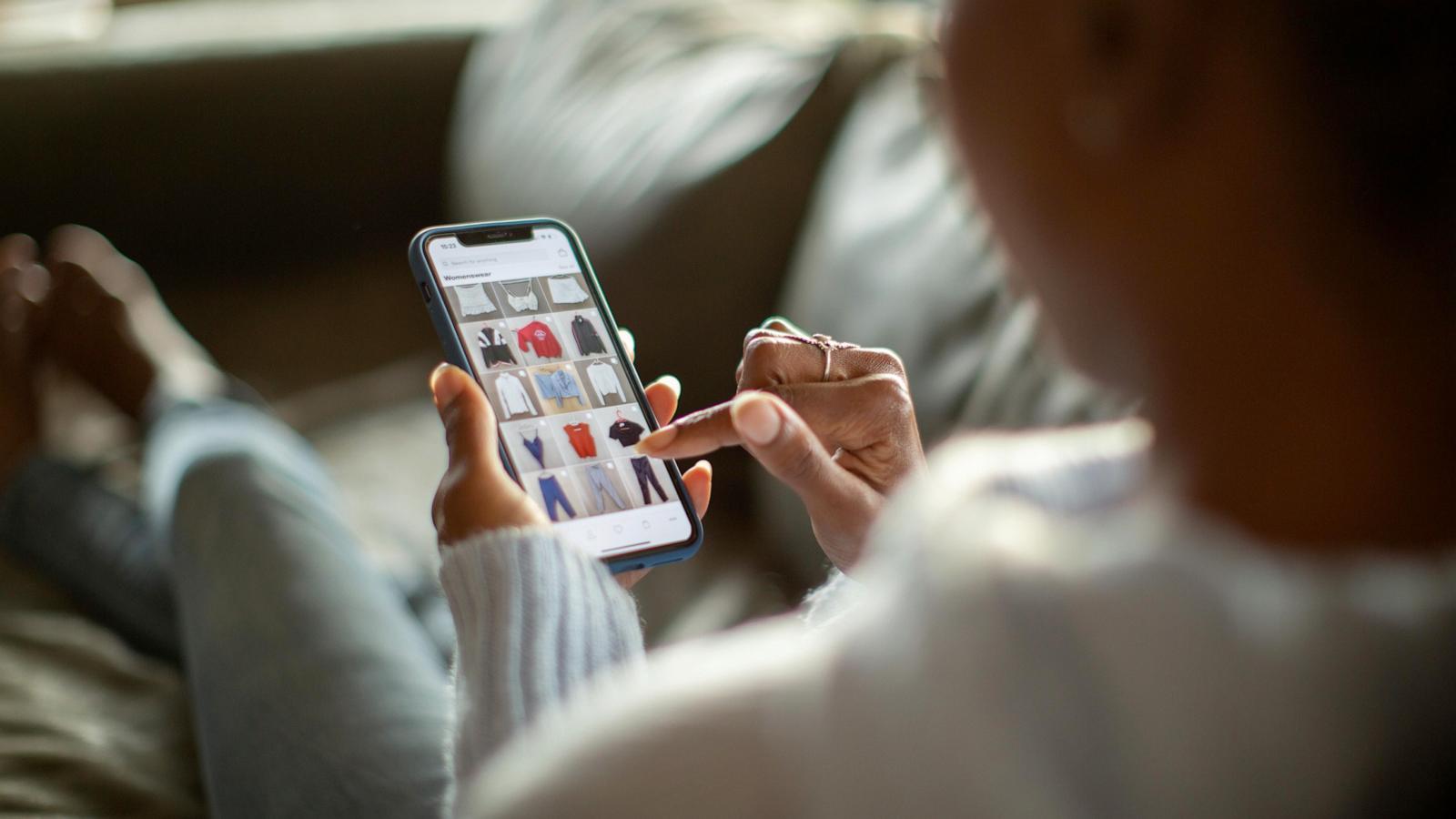 PHOTO: Stock photo of a person shopping on their mobile device.